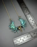 Golden Moose Skull Pendant Necklace – Brass with Green Patina Horns Front